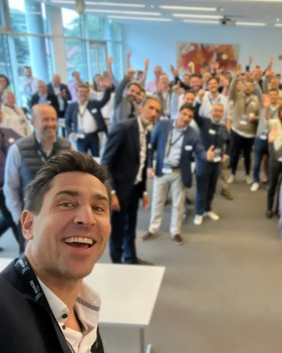 Participants at the close of a workshop session, raising their hands together.