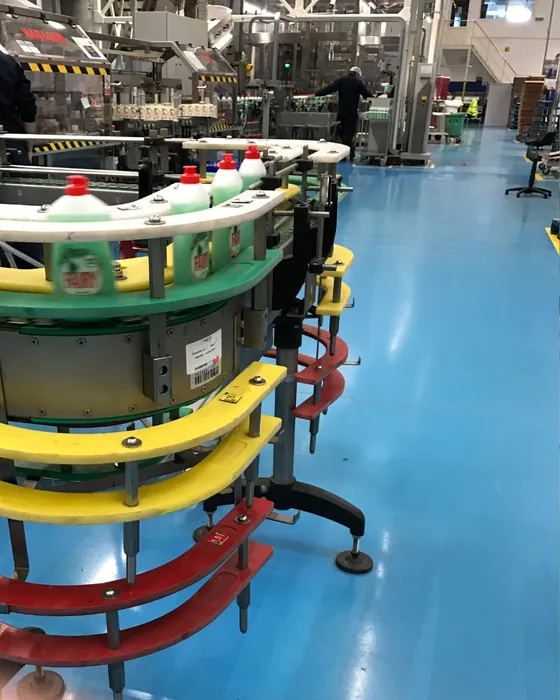 A filling line in operation, containers moving along a rotary transfer table.